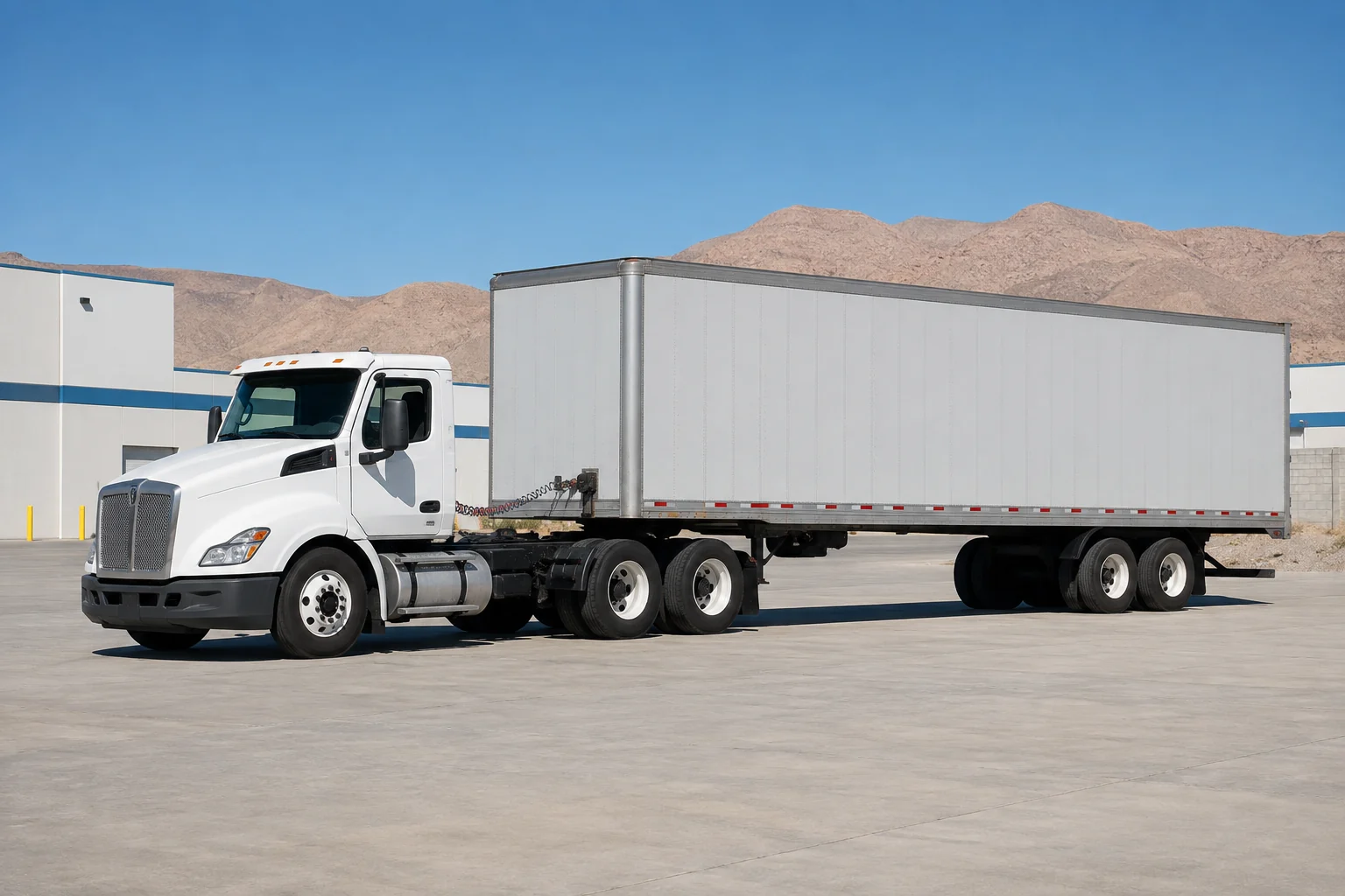 An unbranded day-cab tractor connected to a plain dry-van trailer in a Las Vegas industrial yard